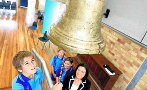 Student Brandon Robinson rings the historic bell in the new building at Tweed Public School while Justine Elliot (right) and students Hayley Bisaro and Elijah Gibbs watch. Student Brandon Robinson rings the historic bell in the new building at Tweed Public School while Justine Elliot (right) and students Hayley Bisaro and Elijah Gibbs watch.